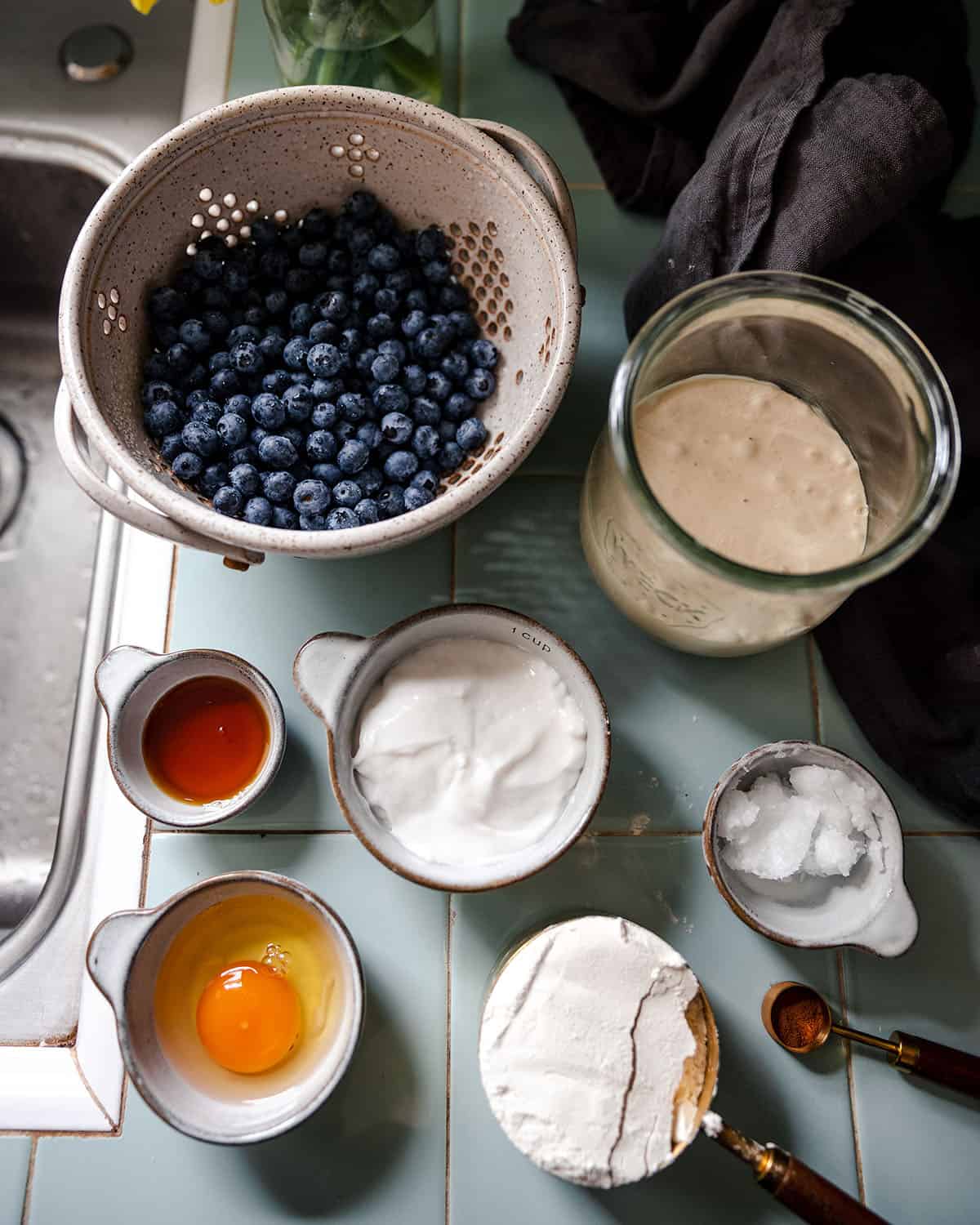 Top view of bowls of ingredients for sourdough blueberry pancakes. 