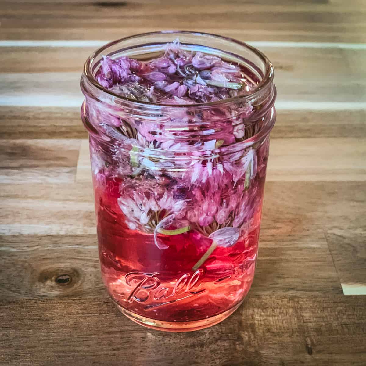 A jar of chive blossom infused vinegar.