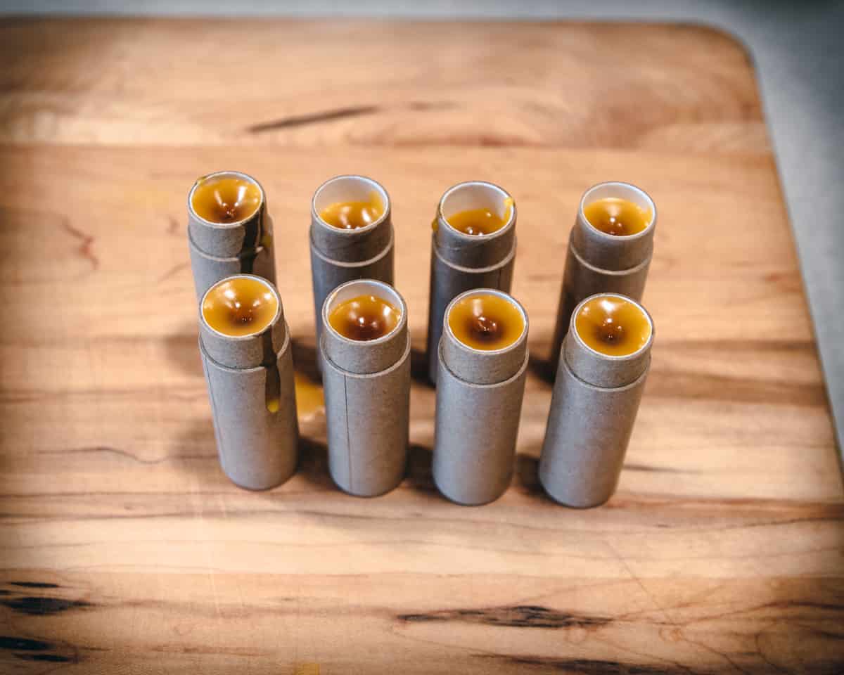 2 rows of 4 calendula lip balms in paper tubes setting. 