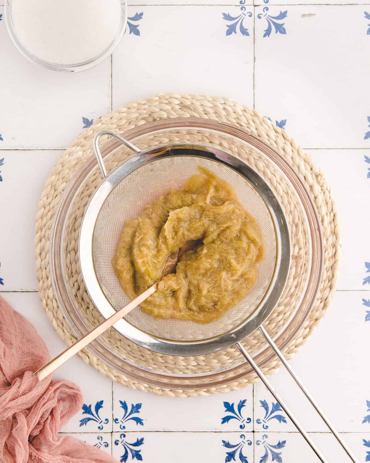 A strainer with the leftover mash of rhubarb after boiling. 