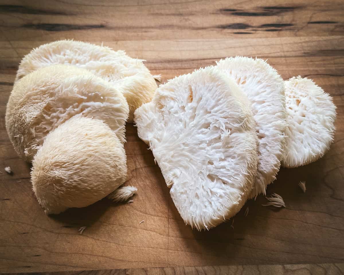 Sliced lion's mane mushrooms on a cutting board. 