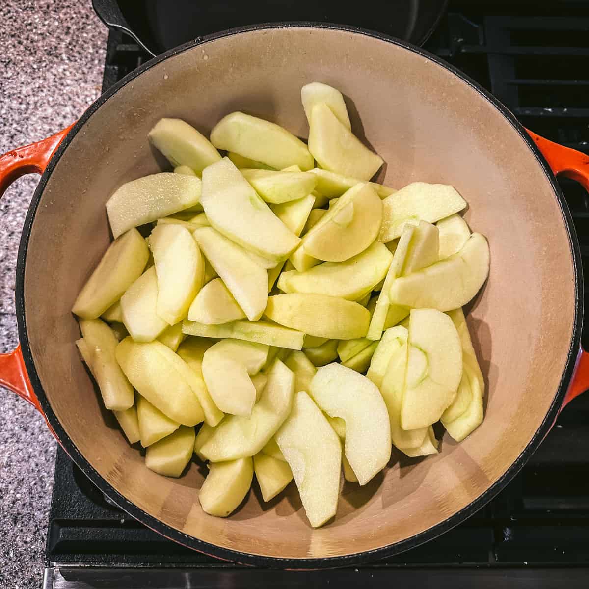 Sliced apples in a pot, top view.