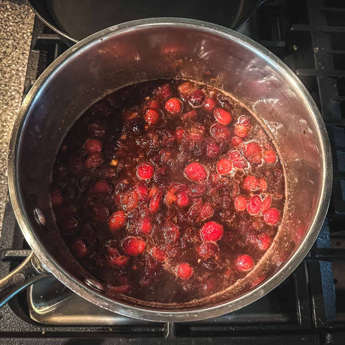 Cooked cranberries resting in a pot, top view. 