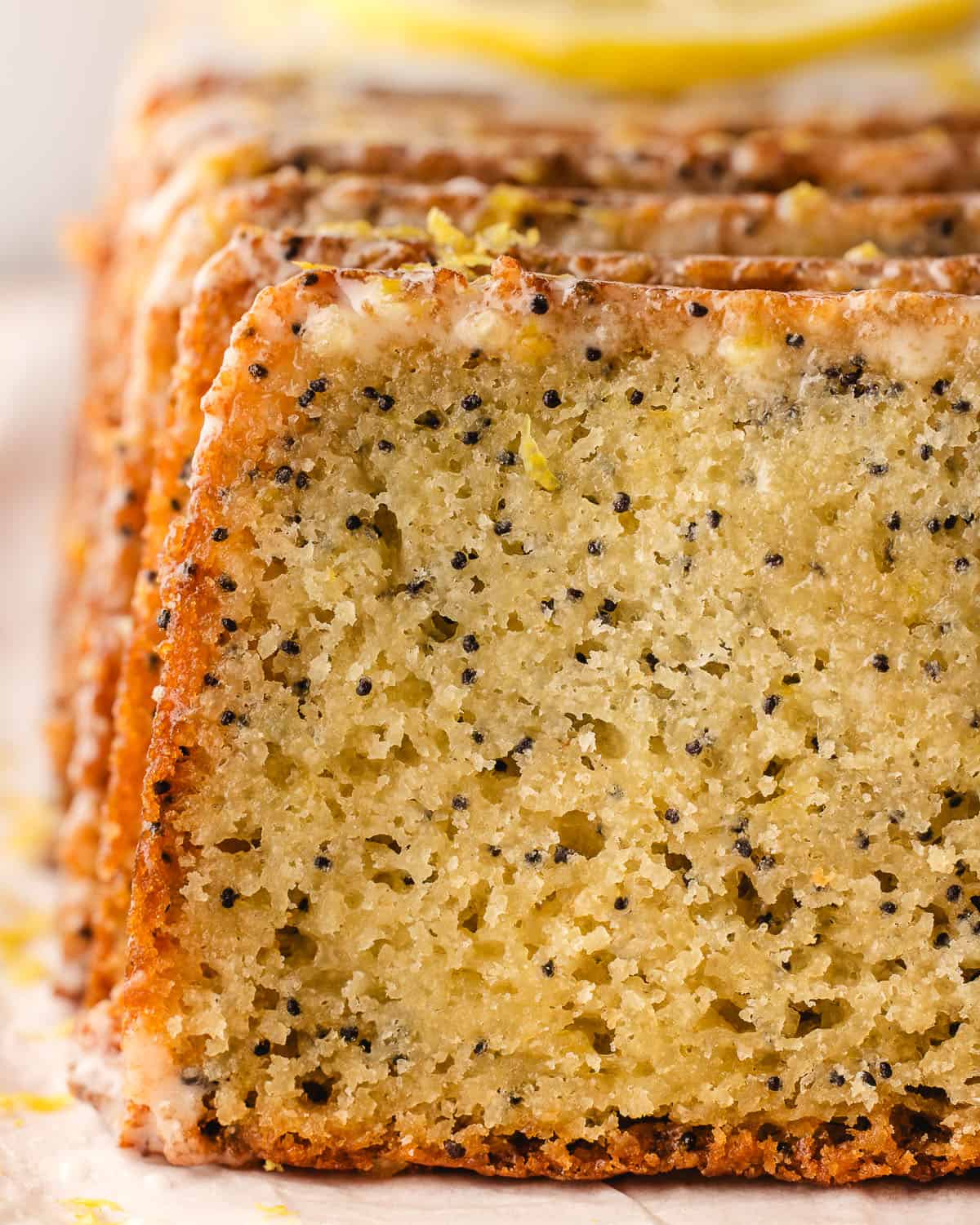 A close up of the sliced side of a lemon poppy seed loaf. 
