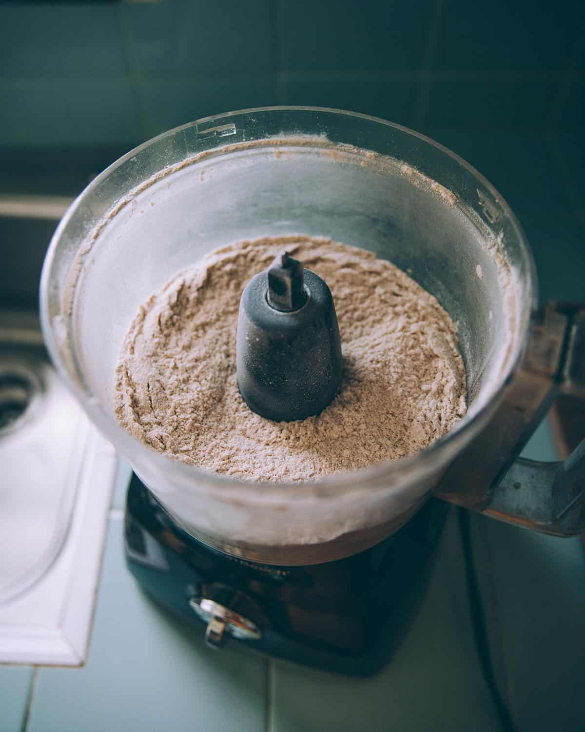 A food processor with dry ingredients. 