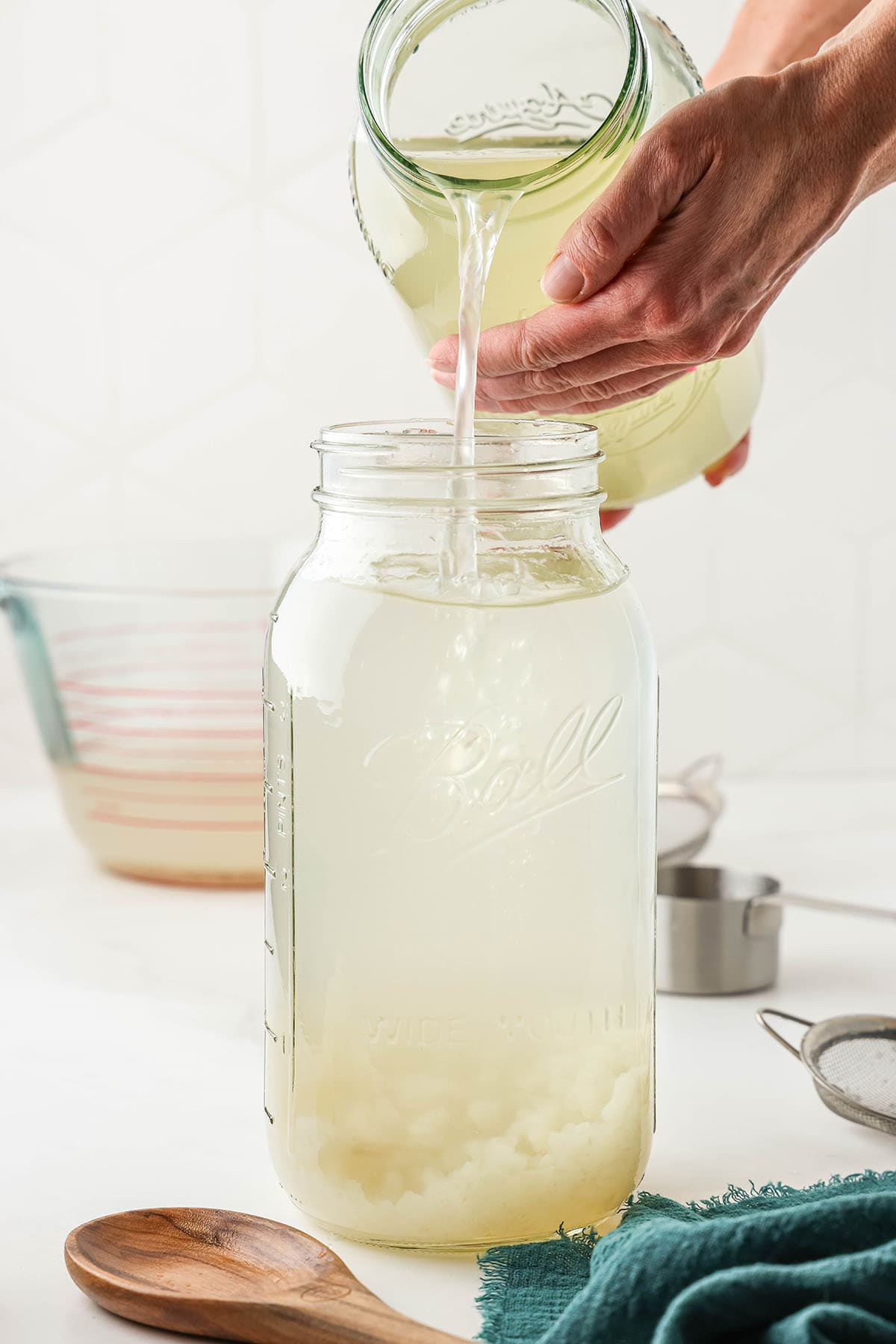 Water kefir starter being added into the jar. 