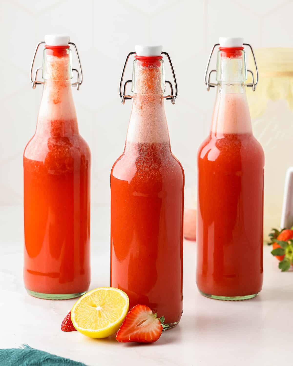 Filled flip top bottles with strawberry water kefir ready for its second ferment.