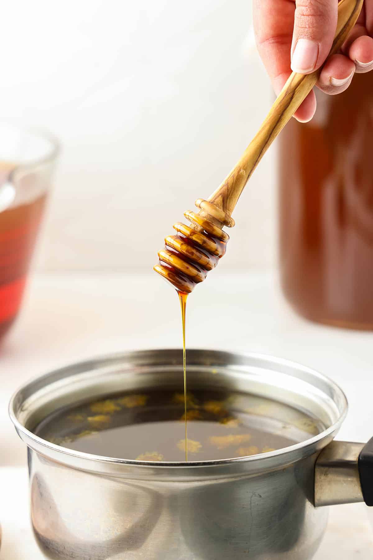 Honey drizzling into the pot of dandelion tea. 
