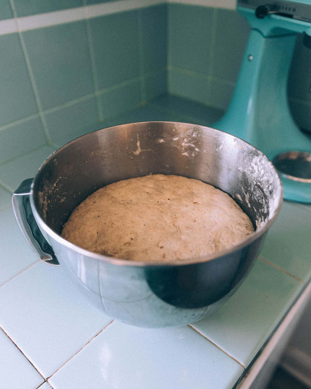 A metal bowl of dough. 