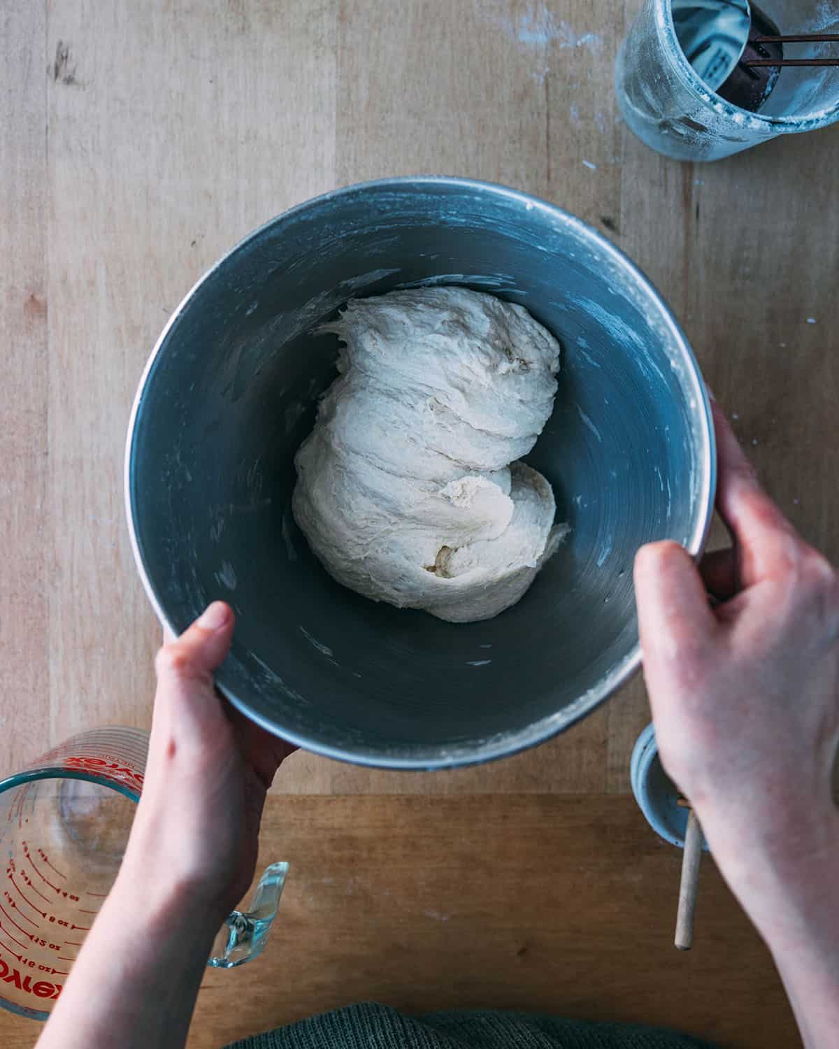 Sourdough pizza dough in a bowl before rising, top view. 