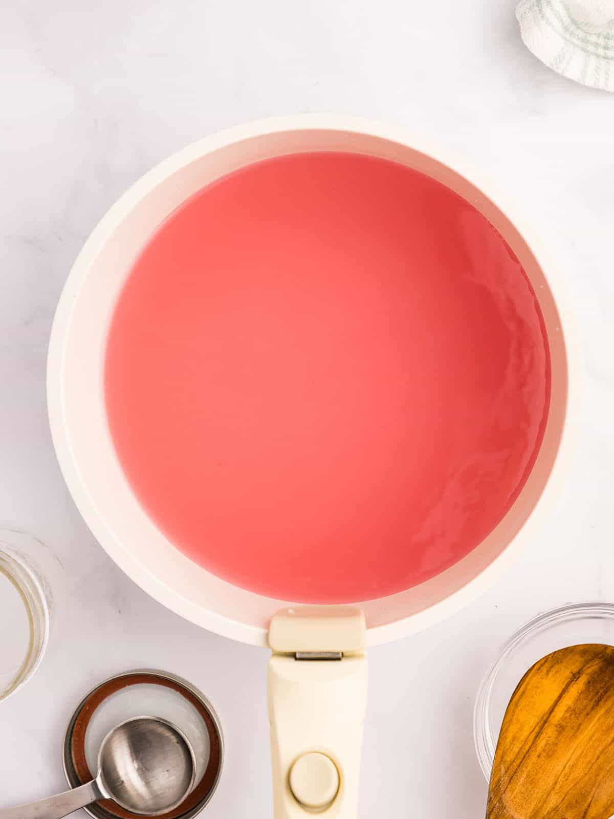 Lemon juice is added to the violet tea in the pot, making it pink. Top view. 