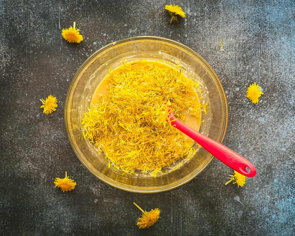 Dandelion petals in the bowl with the mixed ingredients. 