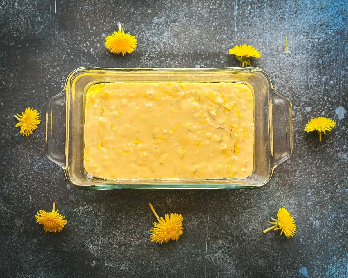 Dandelion bread batter in a loaf pan.