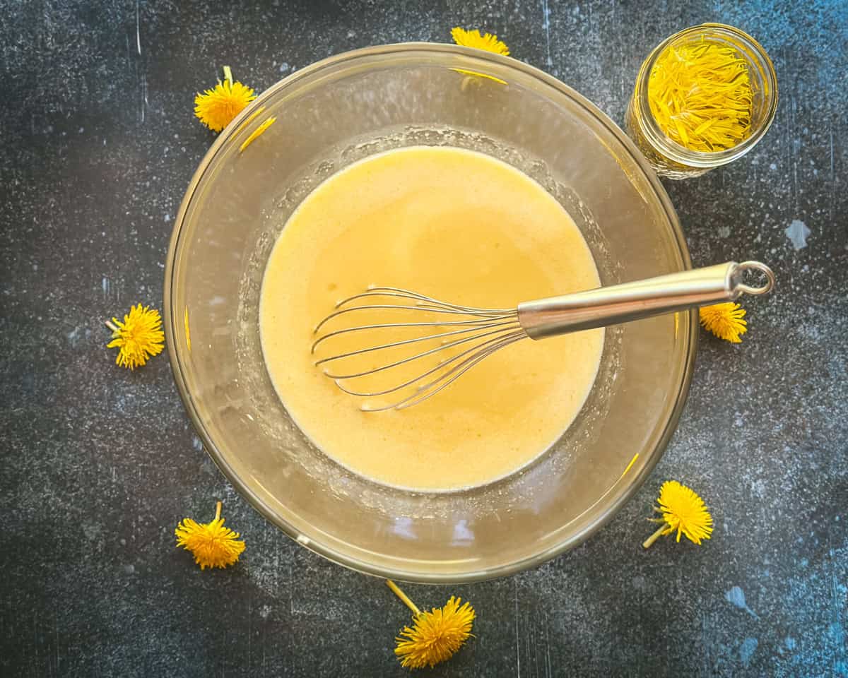 Wet ingredients in a bowl with a whisk.