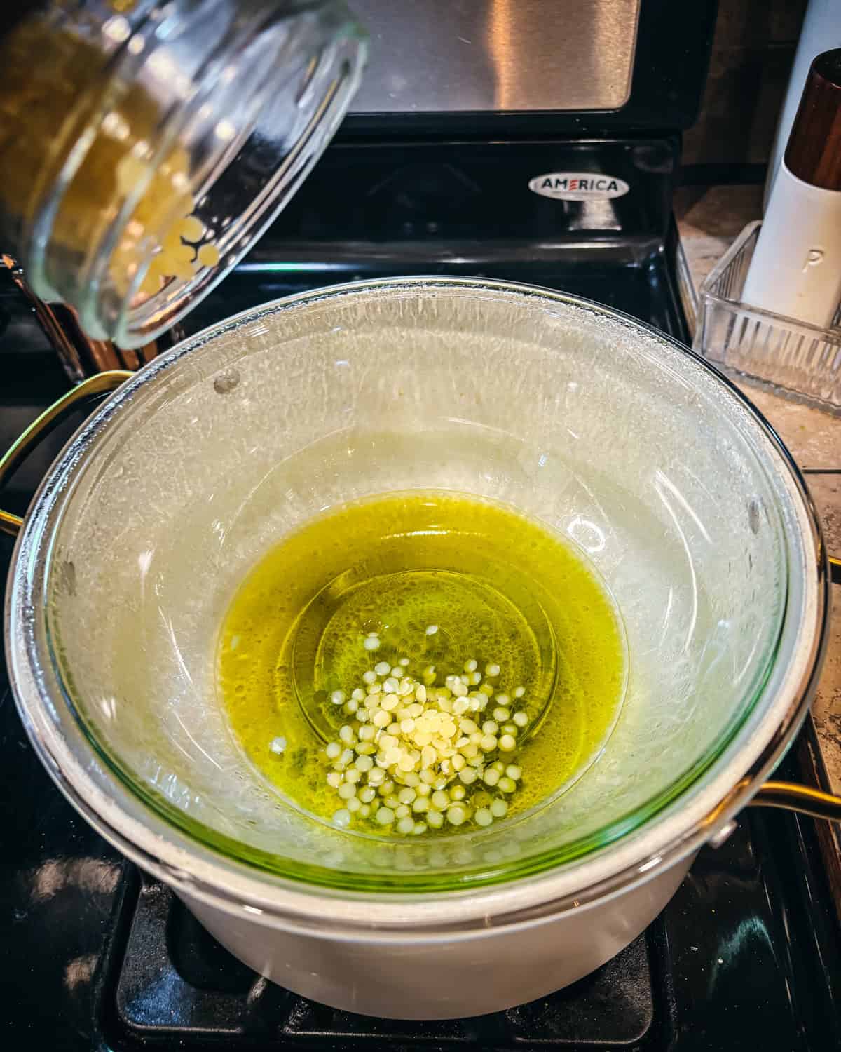 Beeswax melting into infused oil in a makeshift double boiler. 